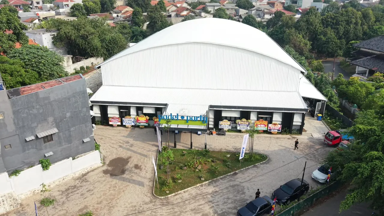 Inside the Padel Party arena in Depok, club banners hanging under the roof